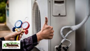 Air conditioning, HVAC service technician using gauges to check refrigerant and add refrigerant