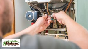 tech repairing Gas Furnace