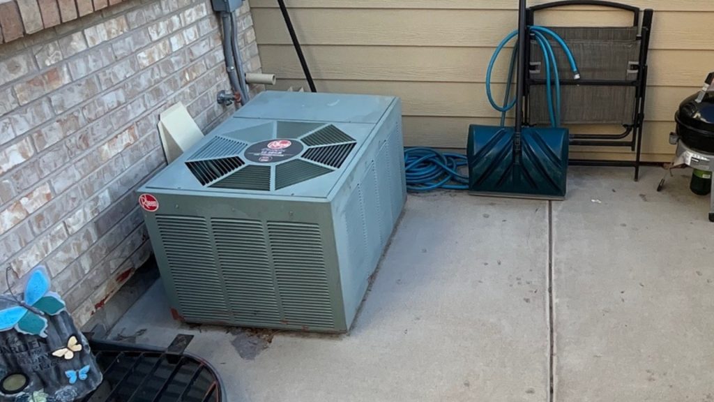 a backyard with an air conditioner and other items