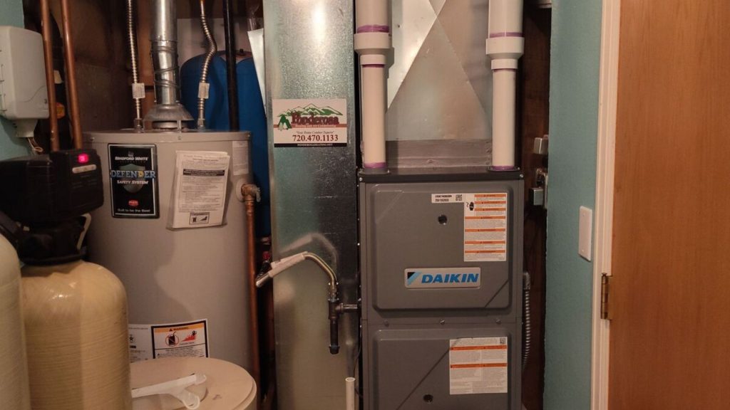 a gas furnace and water heater in a small room