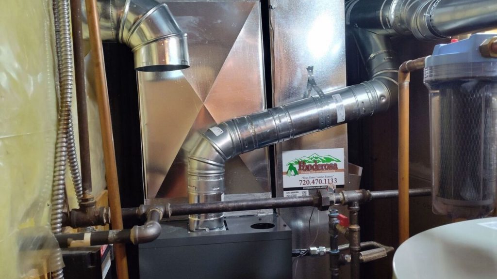 a gas furnace and water heater in a small room