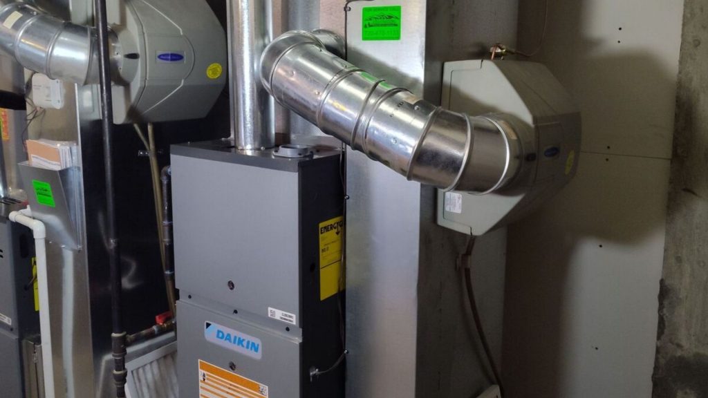 a gas furnace in a room with pipes and duct work (2)