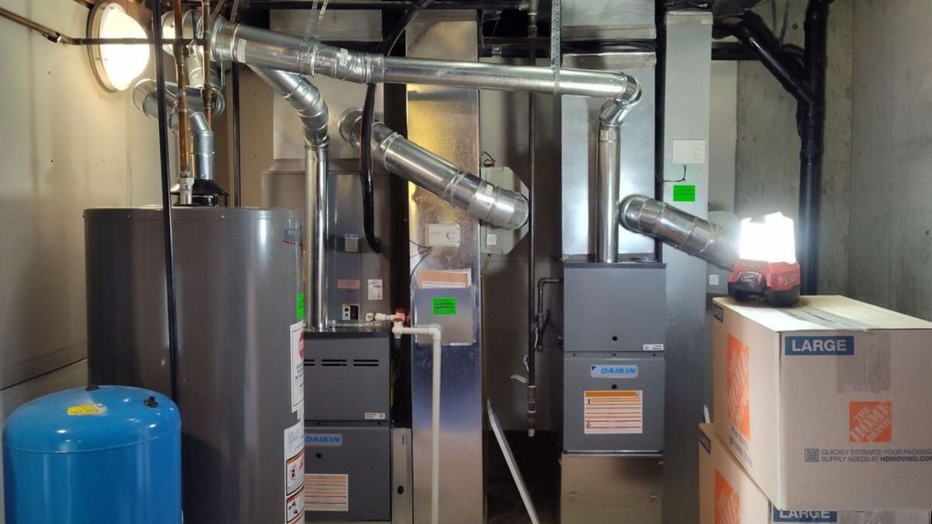 a room with a furnace, water heater, and other equipment