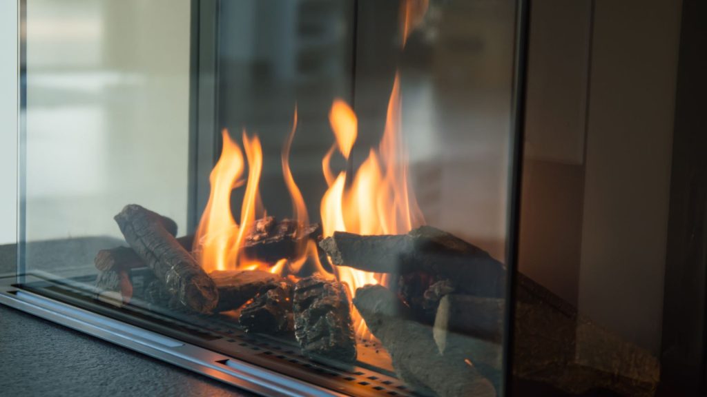 a close up of a fire in a glass fireplace