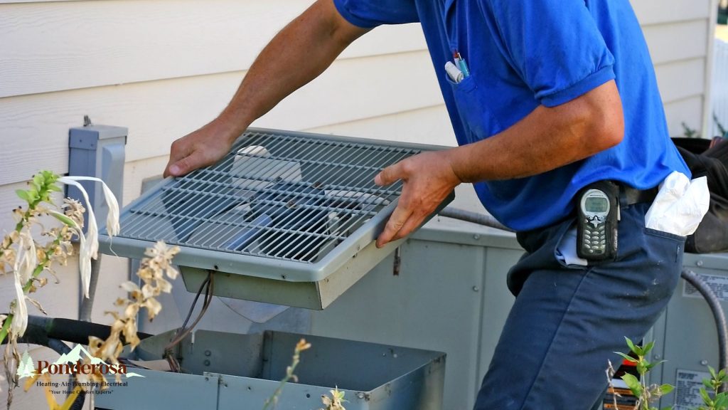 A person in blue shirt working on an air conditioner