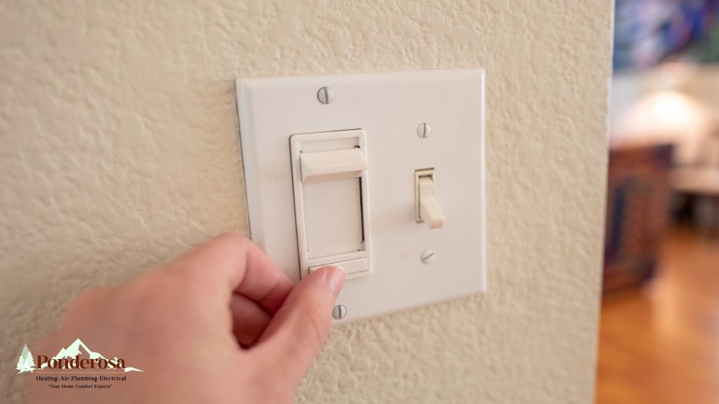 A person is turning a light switch on and off