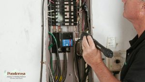 A person is working on an electrical panel