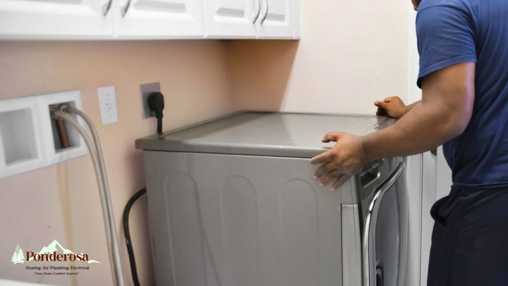 A person standing in front of a washer and dryer