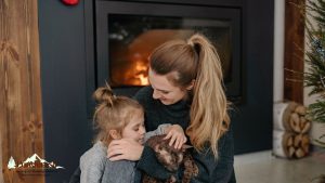 a family and their cat in front of a gas fireplace
