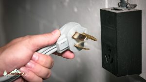 a person is plugging an dryer electrical outlet into a wall